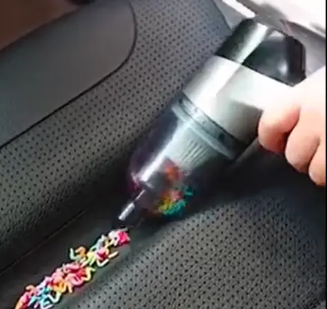 lady holds EZVac Pro and cleans candy